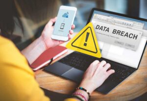 Woman Laptop Phone Data Breach Warning